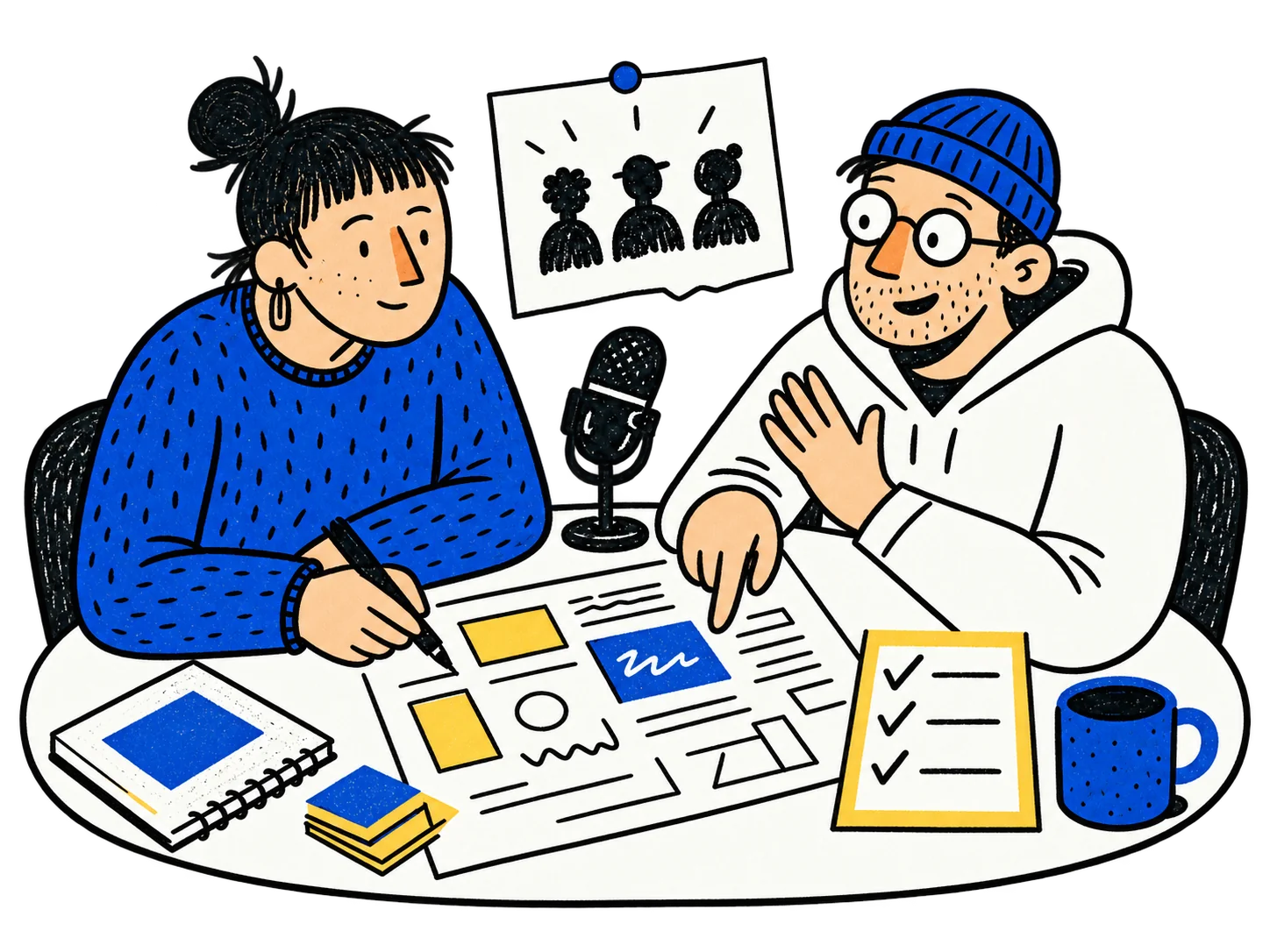 Two creators planning a launch at a table with a microphone